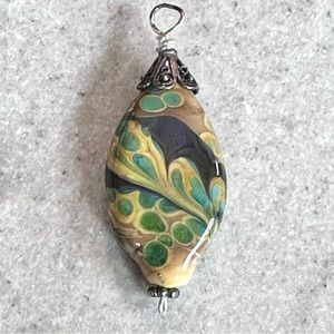 Handmade glass lampwork bead pendant some iridescence.
